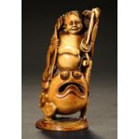 A JAPANESE CARVED AND STAINED IVORY FIGURE OF GAMA SEN'NIN AS A TOAD, MEIJI PERIOD 13cm h ++In