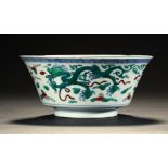 A CHINESE DOUCAI DRAGON BOWL, QING DYNASTY of flared form, 16cm diam, Yongzheng mark within