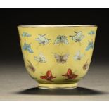 A CHINESE YELLOW GROUND PORCELAIN 'BUTTERFLY' CUP, QING DYNASTY 6.5cm h, Tongzhi mark and of the