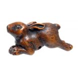 A JAPANESE WOOD NETSUKE OF A RUNNING HARE, SIGNED YOSHITSUGU, EDO PERIOD, 18TH C the eyes inlaid,