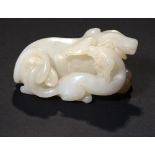 A CHINESE WHITE JADE PEBBLE CARVING OF TWO DOGS 7.7cm ++In good condition