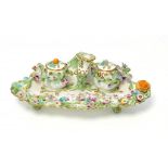 AN ENGLISH PORCELAIN FLORAL ENCRUSTED INKSTAND, C1825 THE ENTWINED HANDLE SET WITH A TAPERSTICK,