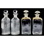 A PAIR OF FLUTED AND CUT GLASS OVAL SPIRIT DECANTERS AND STOPPERS OF DOUBLE LIPPED FORM, 19CM H,