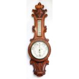 A CARVED OAK ANEROID BAROMETER BY T. ARMSTRONG OF MANCHESTER, 71CM H