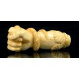 A 19TH CENTURY CARVED MARINE IVORY CANE HANDLE IN THE FORM OF A SNAKE IN A CLENCHED FIST, 8.5CM H