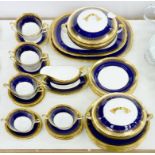 AN AYNSLEY COBALT AND RICHLY GILT DINNER SERVICE, INCLUDING A PAIR OF VEGETABLE DISHES AND COVERS