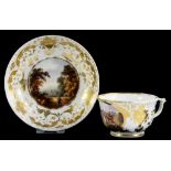 A DERBY TEACUP AND SAUCER, PAINTED WITH A THATCHED COTTAGE OR TRAVELLER IN A LANDSCAPE IN RICHLY