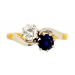 A SAPPHIRE AND DIAMOND CROSSOVER RING with a diamond of approx 0.25ct, in gold, marked 18CT &