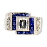 A SAPPHIRE AND DIAMOND COCKTAIL RING the larger emerald cut diamond in a surround of calibre cut