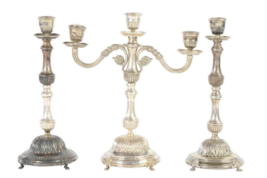 AN EGYPTIAN SILVER GARNITURE, MID 20TH C of twin branch candelabrum and pair of candlesticks, on paw
