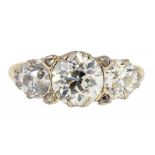 A DIAMOND RING with three old cut diamonds divided by chip diamonds, in 18ct gold, Birmingham