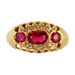 A RUBY AND DIAMOND RING with three larger oval or round rubies in 18ct gold, Birmingham, marks
