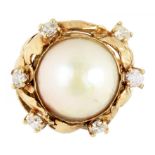 A MABE PEARL AND DIAMOND RING in gold, of leafy foliate openwork design with bifurcated shoulders,