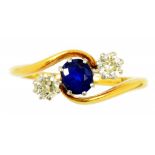 A SAPPHIRE AND DIAMOND THREE STONE CROSSOVER RING in gold, unmarked, 3.6g, size N ++In