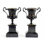 A PAIR OF FRENCH PATINATED BRASS CAMPANA VASES FROM A CLOCK GARNITURE, ON BELGIAN SLATE PLINTHS,