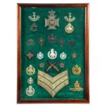 A FRAMED DISPLAY OF NOTTINGHAMSHIRE HEAD DRESS AND OTHER BADGES AND INSIGNIA OF THE ROBIN HOOD