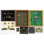 A COLLECTION OF BRITISH MILITARY BRASS AND PLATED HEAD-DRESS BADGES AND OTHER INSIGNIA mounted on