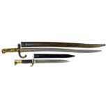 A FRENCH BRASS HILTED SWORD BAYONET AND SHEATH blade 57.5cm and a German bayonet and sheath by