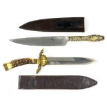 A BOWIE KNIFE the brass hilt with deer slot quillons and shell guard, antler grip, 32cm overall