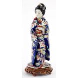 A JAPANESE IMARI PORCELAIN FIGURE OF A BEJIN, 36CM H, C1900, FAULTS WITH A LATER WOOD STAND