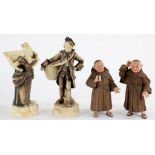 A PAIR OF COMICAL JOURNEY MEN PAINTED BISCUIT FIGURAL SPILL HOLDERS IN THE FORM OF MONKS, 17CM H AND