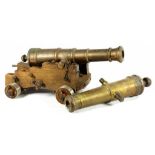 TWO BRONZE MODEL CANNON 37 & 42cm l, one on oak carriage