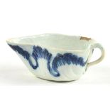 AN UNUSUAL PEARLWARE LEAF SHAPED BUTTER BOAT WITH STALK HANDLE, THE UNDERSIDE IMPRESSED WITH A