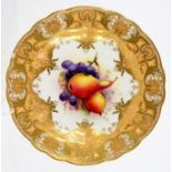 A ROYAL WORCESTER PLATE PAINTED BY R SEBRIGHT, SIGNED, WITH FRUIT IN RICHLY GILT APRICOT BORDER