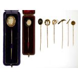 SEVEN GOLD STICKPINS, VARIOUS TERMINALS, ONE IN THE FORM OF A KNIFE WITH HARDSTONE HANDLE, ANOTHER