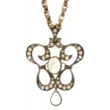 A MOONSTONE, SPLIT PEARL AND DIAMOND OPENWORK PENDANT IN GOLD, EARLY 20TH C, ON A GOLD NECKLACE, 8.