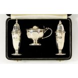 AN ELIZABETH II SILVER THREE PIECE CONDIMENT SET OF PANELLED VASULAR DESIGN, BLUE GLASS LINER,