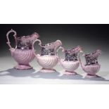 A GRADUATED SET OF FOUR SHELL SHAPED PINK LUSTRE WARE JUGS, C1840 with principal named black