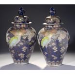 A PAIR OF JAPANESE BLUE GROUND IMARI JARS AND COVERS, MEIJI PERIOD painted in brilliant polychrome