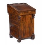 A VICTORIAN ROSEWOOD DAVENPORT, C1860 with sliding top, the sides fitted with ink drawer, side