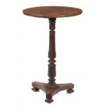 A GEORGE IV ROSEWOOD LAMP TABLE with crossbanded top, the pillar carved with lotus, 73cm h, 48cm