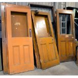 THIRTEEN VARIOUS VICTORIAN AND EARLY 20TH C DOORS of panelled or boarded construction in a