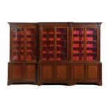 A MAHOGANY BREAKFRONT BOOKCASE, MID 19TH C the cavetto cornice above six glazed doors enclosing