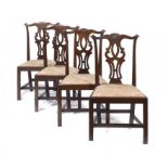 A SET OF FOUR GEORGE III MAHOGANY DINING CHAIRS, C1780 with carved cresting rail and pierced