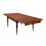 A WILLIAM IV MAHOGANY DINING TABLE the extending top on four lappet carved and turned legs and brass