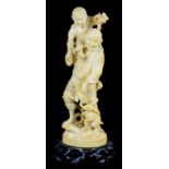 A JAPANESE CARVED IVORY ONE PIECE GROUP OF A MAN CARRYING HIS SMALL SON ON HIS SHOULDER AND