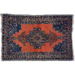 A NORTH WEST PERSIAN RUG. the madder field with a large polychrome central medallion with serrated