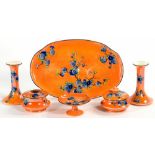 A FIELDING'S DEVON LUSTRE DRESSING TABLE SET, WITH PRUNUS ON AN ORANGE GROUND, TRAY 33CM W, C1920