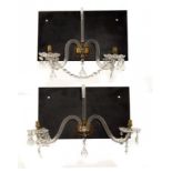 A PAIR OF VICTORIAN ORMOLU MOUNTED CUT GLASS TWIN BRANCH WALL LIGHTS, C1900 hung with prismatic