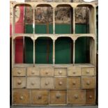 A VICTORIAN PINE SHOP CABINET, WITH OPEN SHELVES AND TURNED UPRIGHTS ABOVE 17 DRAWERS, 158 X