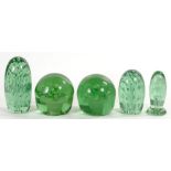 THREE AND A NEAR PAIR OF 19TH C GREEN GLASS 'DUMP' DOOR STOPS', LARGEST 15CM H