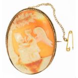 A CAMEO BROOCH, THE OVAL SHELL CARVED WITH A WINGED FIGURE BENEATH A TREE, GOLD MOUNT, MARKED 9CT