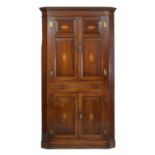 A GEORGE III OAK CORNER CUPBOARD, C1780 of barrel back form with dentil cornice and fitted with