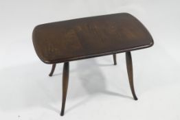 An Ercol beech stained coffee table with turned tapering legs, bears makers label,