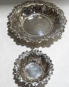 Two matching pierced silver bon bon dishes with chased floral and scroll decoration,