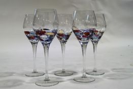 A set of five Italian Milano red wine glasses, with coloured decoration to bowls,